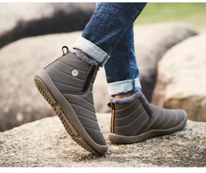 Close-up of brown winter snow boots featuring cozy plush lining and quilted waterproof upper.