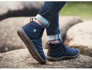 Detailed view of winter fleece lined snow boots, warm waterproof fabric with anti slip rubber sole.