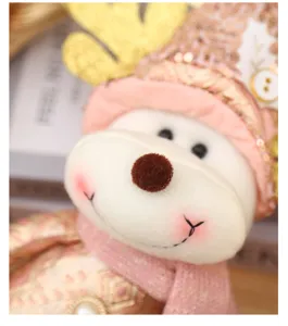 Christmas plush reindeer doll detail close-up, soft pink and gold holiday decoration cute toy