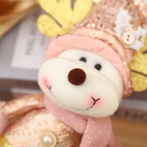 Christmas plush reindeer doll decoration with pink scarf and gold glitter hat for holiday home.