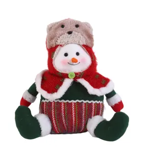 Christmas plush snowman doll with bear hat, cute sitting holiday table decoration for home.