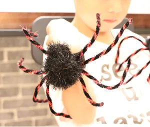 Halloween fuzzy spider slap bracelet toy, black and red plush wristband party prop for kids.