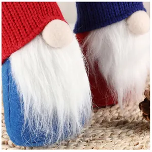 Detail shot of Swedish gnome plush dolls with knitted hats and white beards, holiday decor.