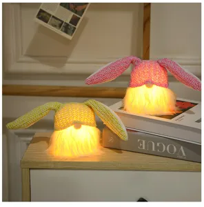 Easter bunny ear gnome plush with warm lights, cute faceless doll for holiday party decor.