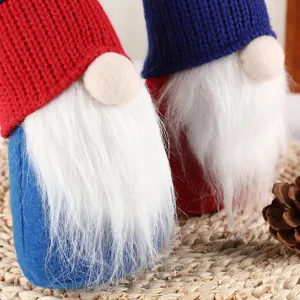 Faceless gnome plush doll decoration with knitted hat and white beard for holiday party table.