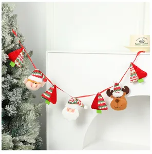 Dettaglio ghirlanda di Natale con ciondoli in peluche renna e Babbo Natale su nastro.
