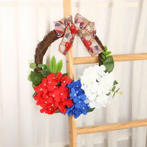 Independence Day decorative wreath with red white blue hydrangeas and patriotic burlap bow.