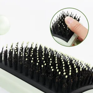 Pet grooming brush with rounded pin heads and soft bristles for comfortable pet hair care.