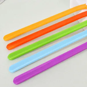 Colorful plastic handle pet toothbrush for dogs and cats, comfortable grip for daily oral care cleaning.