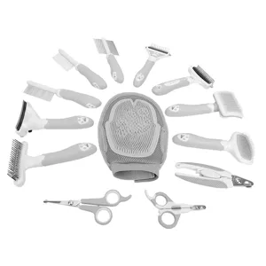 Pet grooming kit with various brushes combs scissors and massage glove in gray and white.