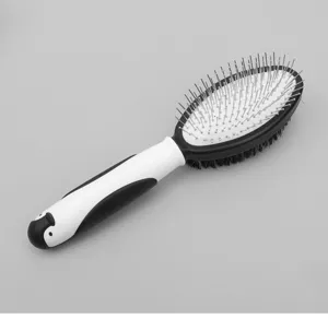 Pet grooming slicker brush detail view showing metal pins and cute penguin handle.