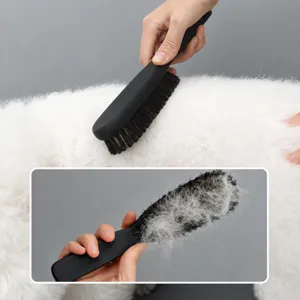 Pet grooming brush for dogs and cats with soft bristles to easily remove hair and fur.