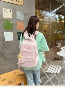 Pink school backpack with star print and cute pendant, large capacity for daily student use.
