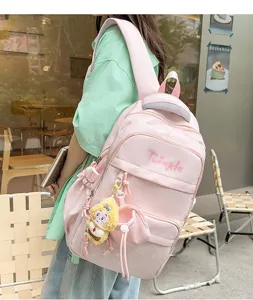 Pink star print school backpack with cute plush pendant, large capacity for students.