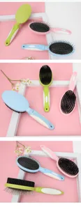 Pet double-sided grooming brush with metal pins and soft bristles for dogs and cats.