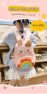 Pink cute rabbit kids backpack with rainbow design and small doll, perfect for school daily.