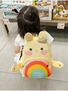 Detailed view of cute cartoon rabbit backpack, colorful rainbow front pocket design for kids.