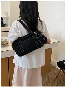 Casual black washed canvas shoulder bag for women, retro style armpit bag with white stitching.