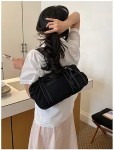 Detailed view of the stylish black canvas shoulder bag for women, casual daily commuter use.