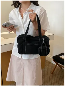 Black canvas shoulder bag vintage style tote bag with contrast stitching and mini pouch detail.