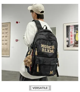 Fashionable camouflage large capacity student backpack with letter embroidery charms