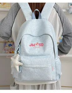 Mochila escolar casual azul claro con colgante de estrella y gran capacidad para uso.