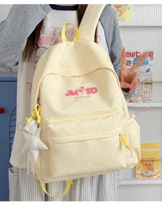 Mochila escolar de lona amarilla de gran capacidad con detalle de colgante de estrella lindo