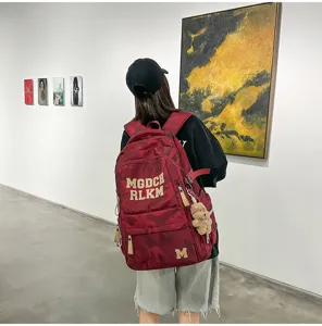 Detail view of a stylish red camo large capacity school backpack for women and students.