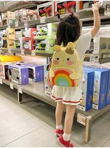Cute cartoon rabbit kids backpack detail view, colorful rainbow design for 3-6 year old girls.