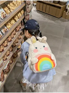 Cute cartoon bunny children schoolbag with colorful rainbow pocket, ideal for kids daily use.