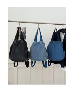 Sac à dos cabas multifonction en denim lavé vintage pour femme et voyage quotidien.