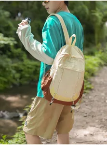 Detail view of a casual forest style outdoor sports backpack with multi pockets and straps.