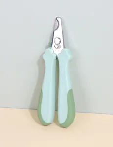 Close-up detail view of stainless steel pet nail clipper featuring ergonomic green handles for pets.