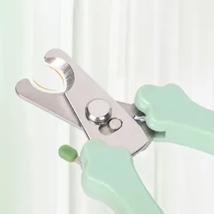 Pet nail clipper with stainless steel semi circular blade and green handle for safe grooming.