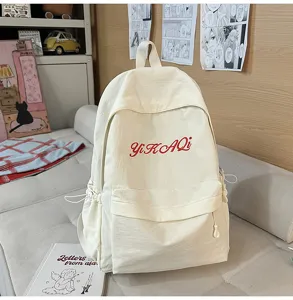 Stilvoller minimalistischer Canvas-Schulrucksack mit roter Stickerei für den täglichen Gebrauch.