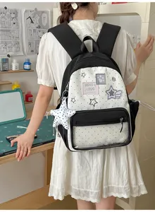 Vista detallada de la bonita mochila de lunares con bolsillo frontal transparente y colgante de estrella.