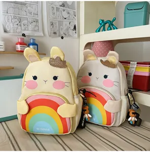 Cute cartoon rabbit children backpack detail, rainbow pattern pocket, soft plush aesthetic.