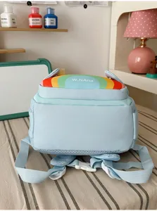 Cute light blue children backpack with rainbow detail and secure buckle for daily school use.