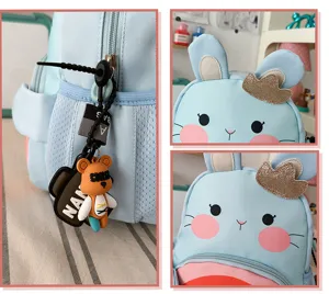 Cute light blue children cartoon backpack with cute rabbit ears and bear pendant for kids.