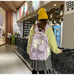 Sac à dos étudiant violet clair avec poche avant transparente, patch étoile et design quotidien.