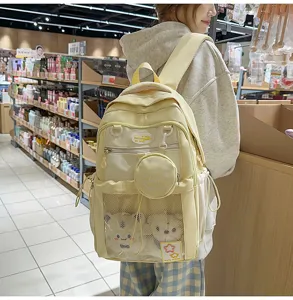 Joli sac à dos scolaire de grande capacité avec poche filet transparente et petite trousse.