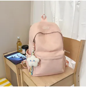 Zaino scolare rosa in nylon per studenti, grande capacità, borsa per libri colore caramella.