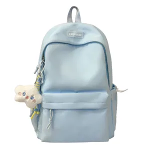 Vista dettagliata della parte anteriore dello zaino in nylon azzurro con tasca e ciondolo.