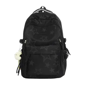 Detail view of black school backpack featuring star print pattern and zipper pockets.
