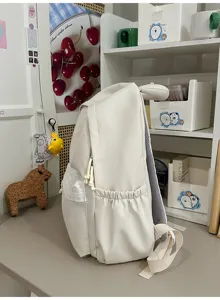 Beigefarbener Schüler Rucksack Seiten Detail zeigt großes Volumen und Ohrendekoration