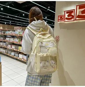 Sac à dos scolaire d'étudiante grande capacité colorblock avec poche filet et peluches.