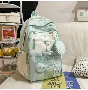 Joli sac à dos scolaire bicolore vert menthe grande capacité avec poche filet et porte-monnaie.