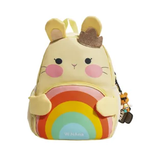 Detail view of cute yellow cartoon rabbit children backpack with colorful rainbow pocket.