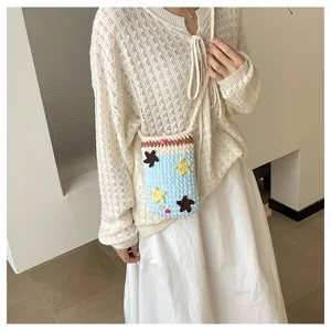 Handmade crochet phone bag detail, cute star pattern contrast design, casual crossbody wear.