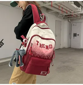 Detailed view of the gradient backpack with letter print, showing large capacity and design.